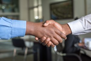 a temp to perm employee shakes the hand of their employer