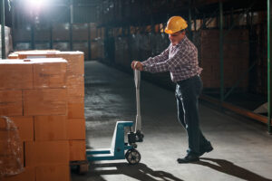 Warehouse worker selecting packages at the storehouse during Night shift.